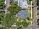 Overhead view showing property lines, mature trees, and landscaping of a home with palm trees and walkway at 635 Bay Ne St, St Petersburg, FL 33701