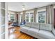 Comfortable sitting area with a cozy couch, bright windows, hardwood floors, and adjacent office space at 635 Bay Ne St, St Petersburg, FL 33701