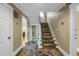 Traditional staircase featuring carpeted treads and hardwood floors in the entryway, complemented by neutral wall tones at 635 Bay Ne St, St Petersburg, FL 33701