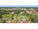Aerial view of a community featuring a tennis court, lush trees, and perfectly manicured landscaping at 780 Sarabay Rd # 16, Osprey, FL 34229