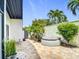 Private backyard oasis with a serene hot tub and lush tropical landscaping at 780 Sarabay Rd # 16, Osprey, FL 34229