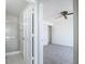 Bright bedroom features neutral carpet, ceiling fan, and an ensuite bathroom with a glass-enclosed shower at 780 Sarabay Rd # 16, Osprey, FL 34229