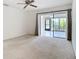 Bedroom featuring sliding glass door with access to a screened lanai at 780 Sarabay Rd # 16, Osprey, FL 34229