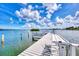 This waterfront property boasts a private boat dock and stunning views of the water under sunny skies at 780 Sarabay Rd # 16, Osprey, FL 34229