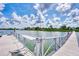 This waterfront property has a private dock and beautiful views of the water and nearby houses under sunny skies at 780 Sarabay Rd # 16, Osprey, FL 34229