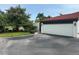 Picture showcases a charming home exterior featuring a white garage door and lush landscaping at 780 Sarabay Rd # 16, Osprey, FL 34229