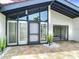 Beautiful front entrance features large windows, a stylish door, and attractive landscaping at 780 Sarabay Rd # 16, Osprey, FL 34229