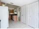 Open kitchen with wood cabinets, white appliances, tiled floors, and a view into the adjacent dining and living areas at 780 Sarabay Rd # 16, Osprey, FL 34229