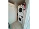Laundry closet equipped with a stacked washer and dryer unit and wire shelving for storage at 780 Sarabay Rd # 16, Osprey, FL 34229