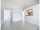 Bright and open living space with tile flooring throughout, offering views into the kitchen and entryway at 780 Sarabay Rd # 16, Osprey, FL 34229