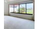 Bright living room featuring a large window with a view of lush landscaping at 780 Sarabay Rd # 16, Osprey, FL 34229