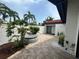 Private outdoor patio with brick pavers, hot tub, and lush tropical landscaping at 780 Sarabay Rd # 16, Osprey, FL 34229