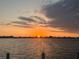 The property features a serene waterfront view with a beautiful sunset and a hint of land in the distance at 780 Sarabay Rd # 16, Osprey, FL 34229
