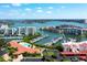 Aerial view of waterfront community with marina, pools, tennis courts and lush landscaping at 7907 Sailboat Key S Blvd # 108, South Pasadena, FL 33707