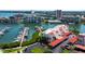 This aerial view showcases a condo community with marina, covered parking, and lush landscaping near the bay at 7907 Sailboat Key S Blvd # 108, South Pasadena, FL 33707