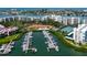 Overhead shot features a marina filled with boats, a community pool, tennis courts, and surrounding condo buildings at 7907 Sailboat Key S Blvd # 108, South Pasadena, FL 33707
