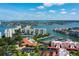 Panoramic aerial view showcasing waterfront condos, a marina, and a pool, all under a clear blue sky with scattered clouds at 7907 Sailboat Key S Blvd # 108, South Pasadena, FL 33707