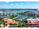 Aerial view with a boat filled marina plus tennis courts and swimming pool in a condo community at 7907 Sailboat Key S Blvd # 108, South Pasadena, FL 33707
