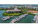 Elevated view showcases the building's marina, surrounded by lush greenery and beautiful waterfront condos at 7907 Sailboat Key S Blvd # 108, South Pasadena, FL 33707