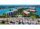 Stunning aerial view of a waterfront community with lush landscaping, multiple buildings, and a picturesque entry way at 7907 Sailboat Key S Blvd # 108, South Pasadena, FL 33707