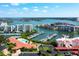 An aerial view showcases the marina, pool, and tennis courts, all nestled within a waterfront condo community at 7907 Sailboat Key S Blvd # 108, South Pasadena, FL 33707