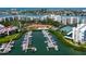 Overhead shot features a marina filled with boats, a community pool, tennis courts, and surrounding condo buildings at 7907 Sailboat Key S Blvd # 108, South Pasadena, FL 33707