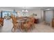 Dining area with rattan chairs, tile flooring, and living area views at 7907 Sailboat Key S Blvd # 108, South Pasadena, FL 33707