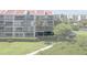 Exterior view of waterfront condos with balconies, well-kept landscaping, and a sidewalk at 7907 Sailboat Key S Blvd # 108, South Pasadena, FL 33707