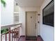 Front door with welcome mat on tile flooring and exterior walls at 7907 Sailboat Key S Blvd # 108, South Pasadena, FL 33707