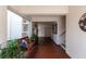 Hallway with tile flooring, bench, stairs and elevator access with neutral walls and plants at 7907 Sailboat Key S Blvd # 108, South Pasadena, FL 33707
