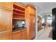 Kitchen pantry with open shelving and sleek countertops, open to dining area at 7907 Sailboat Key S Blvd # 108, South Pasadena, FL 33707