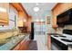 Well-equipped kitchen featuring granite countertops, wood cabinets, and modern appliances at 7907 Sailboat Key S Blvd # 108, South Pasadena, FL 33707