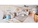 Bright living room with coastal decor, tile flooring, a ceiling fan, and comfortable seating at 7907 Sailboat Key S Blvd # 108, South Pasadena, FL 33707