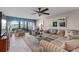 Inviting living room with comfortable seating, ceiling fan, view to the balcony, and a calm color palette at 7907 Sailboat Key S Blvd # 108, South Pasadena, FL 33707