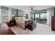 Comfortable main bedroom featuring a ceiling fan, a sliding glass door to the balcony, and stylish decor at 7907 Sailboat Key S Blvd # 108, South Pasadena, FL 33707