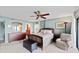 Serene main bedroom with a ceiling fan, a chest of drawers, a plush recliner, and comfortable decor at 7907 Sailboat Key S Blvd # 108, South Pasadena, FL 33707