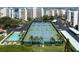Aerial shot of well-maintained tennis and shuffleboard courts surrounded by lush landscaping and condo buildings at 7907 Sailboat Key S Blvd # 108, South Pasadena, FL 33707