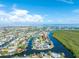 Aerial view showcases the waterfront property's location with access to the bay, set among residential neighborhoods at 909 Silver Palm Way, Apollo Beach, FL 33572