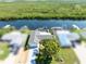 Stunning aerial view of waterfront home featuring a private dock, lush mangrove views and well-manicured landscaping at 909 Silver Palm Way, Apollo Beach, FL 33572