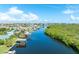 Scenic aerial view of a waterfront neighborhood with private docks, boat access, and lush green surroundings at 909 Silver Palm Way, Apollo Beach, FL 33572