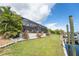Beautiful waterfront home with lush lawn and private boat dock at 909 Silver Palm Way, Apollo Beach, FL 33572