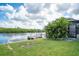 Beautiful backyard with lush landscaping and a private dock on the water at 909 Silver Palm Way, Apollo Beach, FL 33572