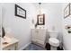 Charming powder room with wainscoting, classic fixtures, and a decorative mirror creating an inviting ambiance at 909 Silver Palm Way, Apollo Beach, FL 33572