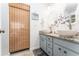 Stylish bathroom with double vessel sinks, granite countertops, and a bamboo shade adding a touch of natural elegance at 909 Silver Palm Way, Apollo Beach, FL 33572