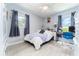 Comfortable bedroom with a light color, light wood floors, and lots of natural light at 909 Silver Palm Way, Apollo Beach, FL 33572