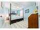 A comfortable bedroom with ceiling fan, a four-poster bed, and stylish decor at 909 Silver Palm Way, Apollo Beach, FL 33572