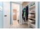 Organized walk-in closet with shelving, hanging space, and easy access to an adjacent bathroom for convenience at 909 Silver Palm Way, Apollo Beach, FL 33572
