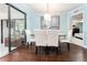 The dining room has a glass table, white chairs, a sliding glass door, and access to a bedroom at 909 Silver Palm Way, Apollo Beach, FL 33572