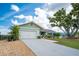 Charming single-story home featuring an attached two-car garage and well-manicured lawn at 909 Silver Palm Way, Apollo Beach, FL 33572