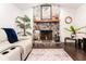 Living room featuring a stone fireplace with a wooden mantel, and dark floors with area rug at 909 Silver Palm Way, Apollo Beach, FL 33572